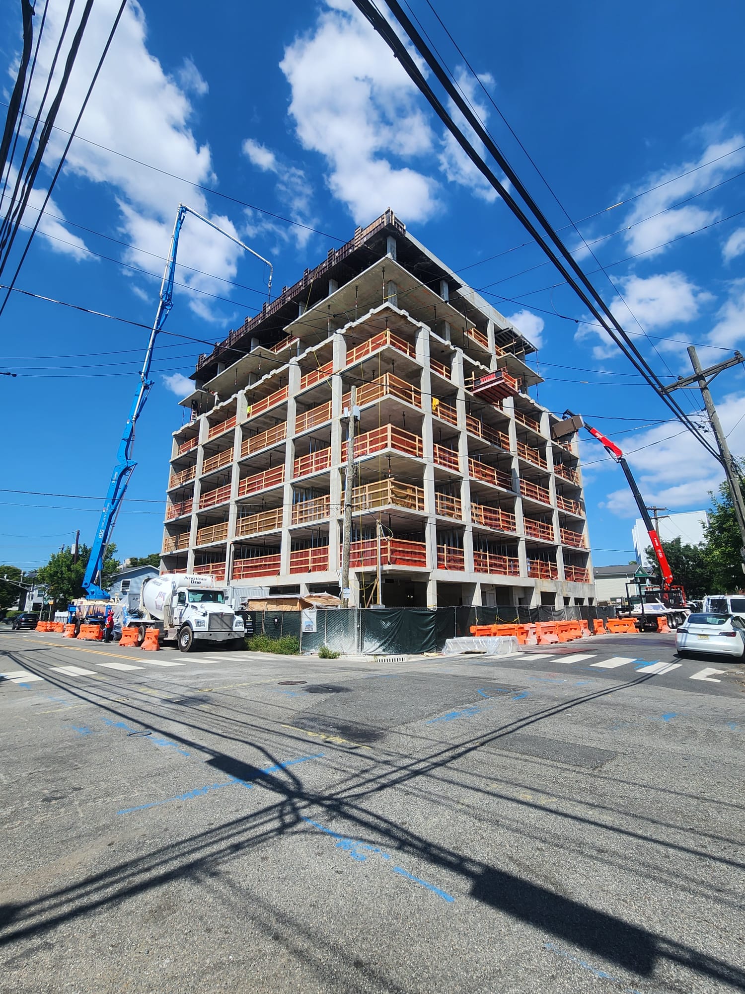 Multi-story residential building under construction with formwork